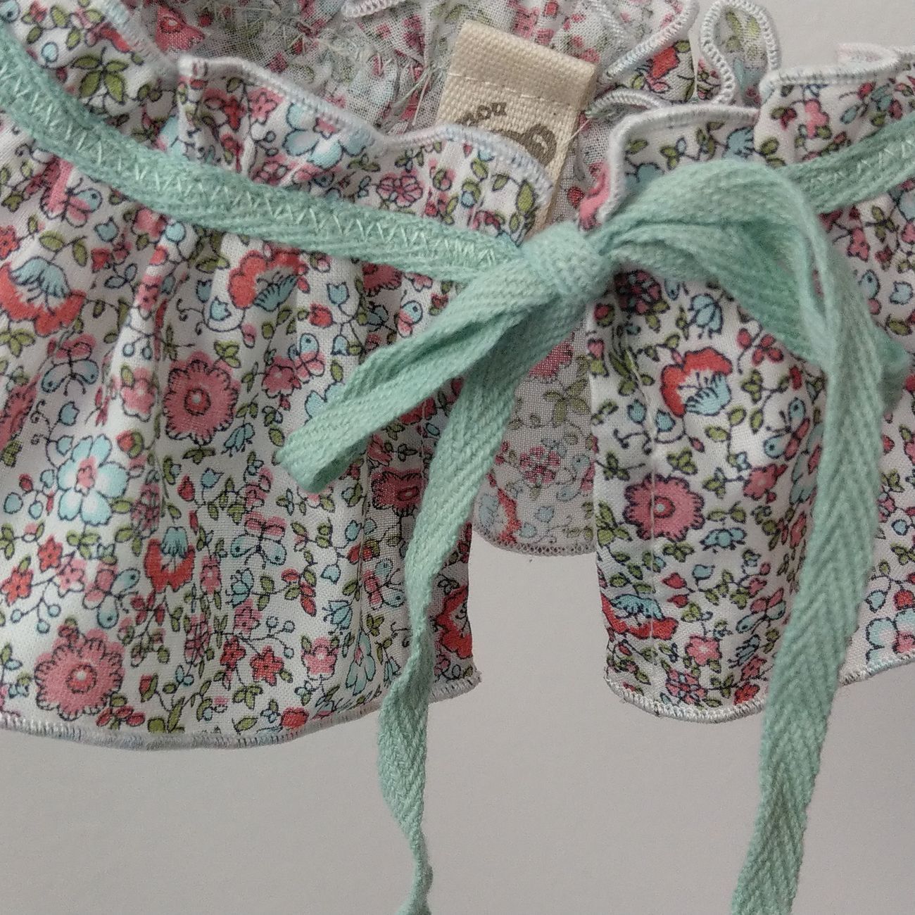 Colletto per bambina in tessuto a fiorellini azzurri e rosa da annodare