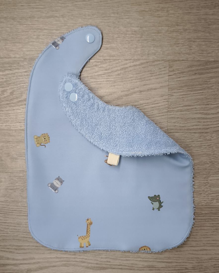 Bavaglino cerato azzurro con animaletti baby - retro in spugna azzurra