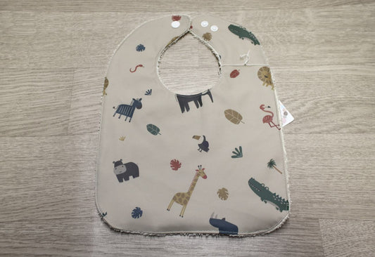 Bavaglino cerato con animaletti della savana su beige - retro in spugna