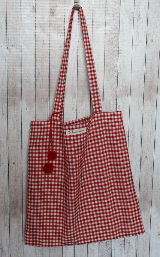 shopper in tela a quadretti rossi con pom pon rossi